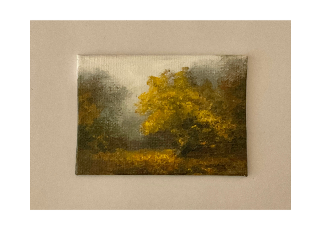 Miniature oil painting of a tree surrounded by woodland in the Autumn.